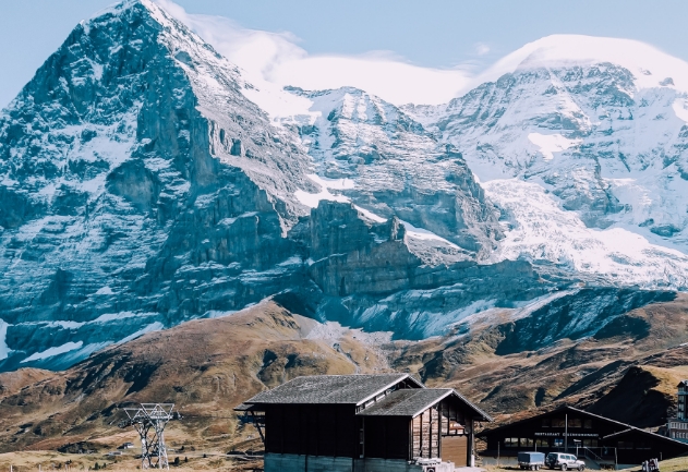 Casas de madeira ao lado de uma montanha com neve